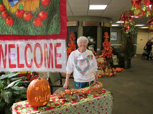 A warm welcome to an autumn event, featuring festive decorations and a smiling volunteer.