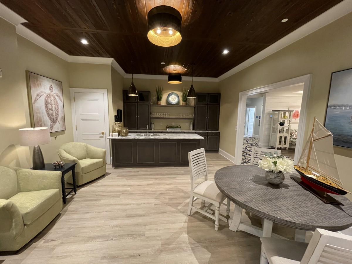 A modern kitchen interior featuring an island counter and cozy seating area.
