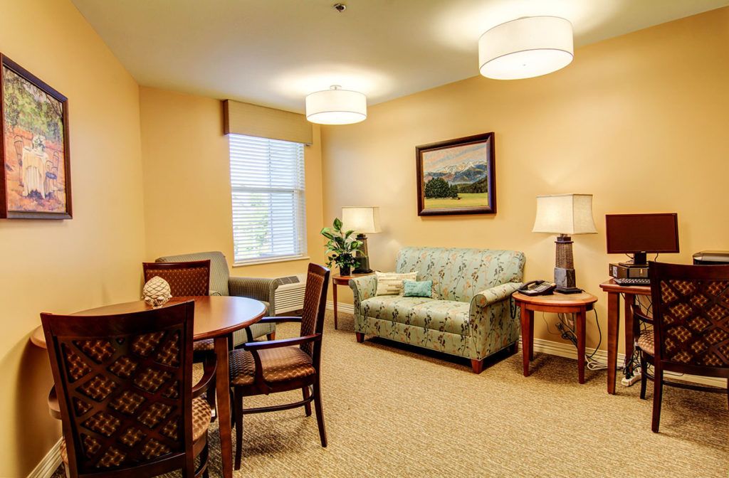 A cozy living room with a sofa, table, and warm lighting.