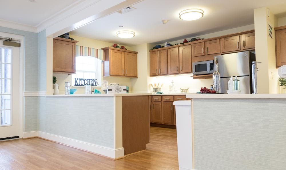 A modern kitchen with wooden cabinets and stainless steel appliances.