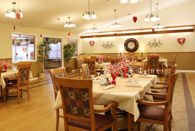 A warmly decorated restaurant interior with neatly arranged tables and chairs.