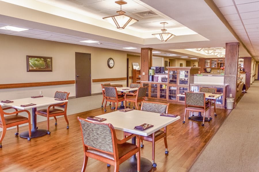 A spacious and well-lit dining area with neatly arranged tables and chairs.