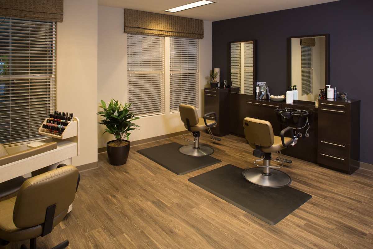 A modern hair salon with comfortable chairs and stylish decor.