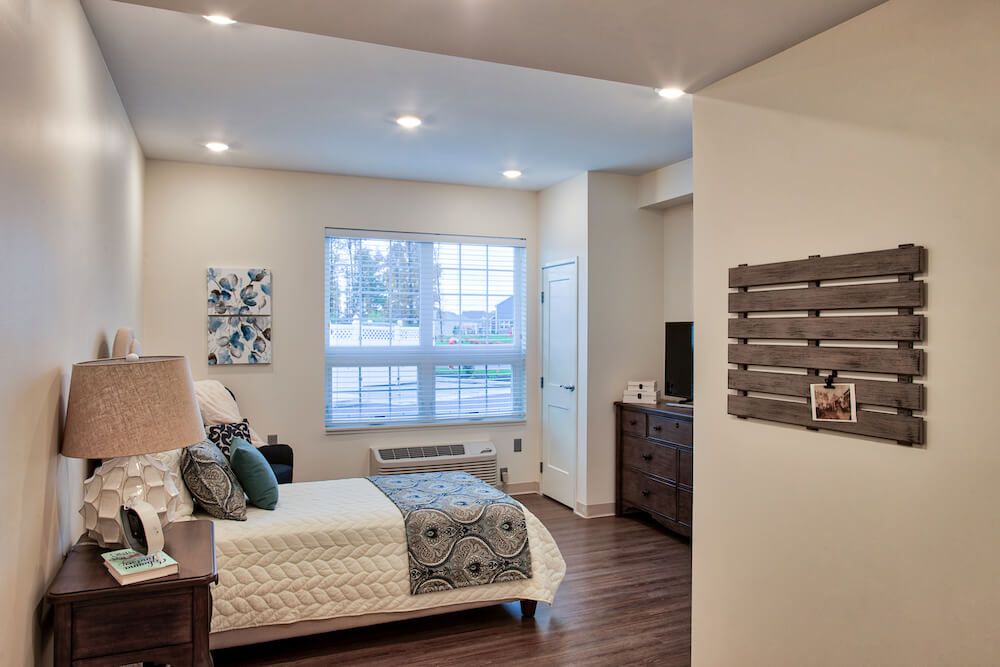 A modern and cozy bedroom with stylish decor and natural light.