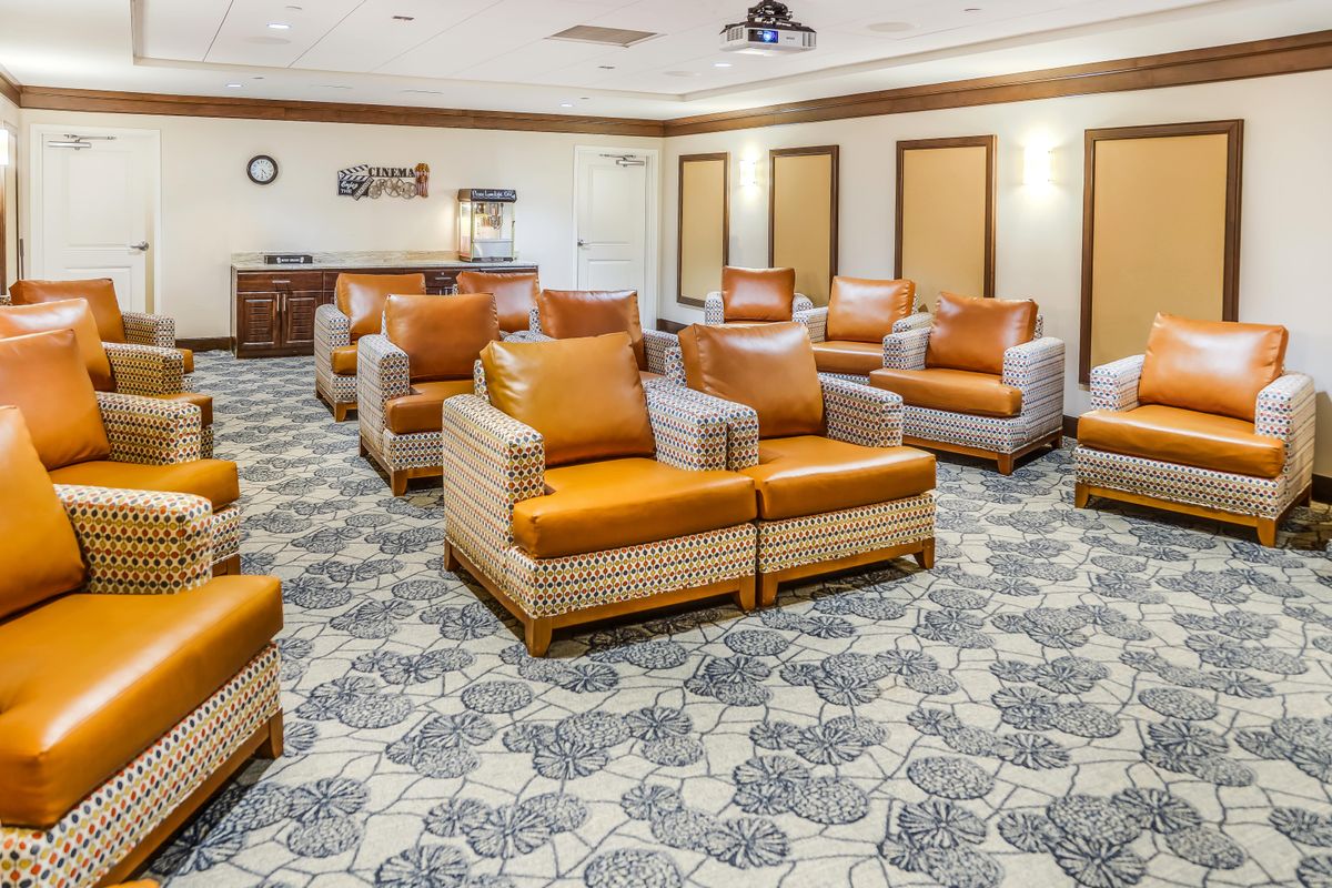 A comfortable lounge area with multiple armchairs arranged on a patterned carpet.