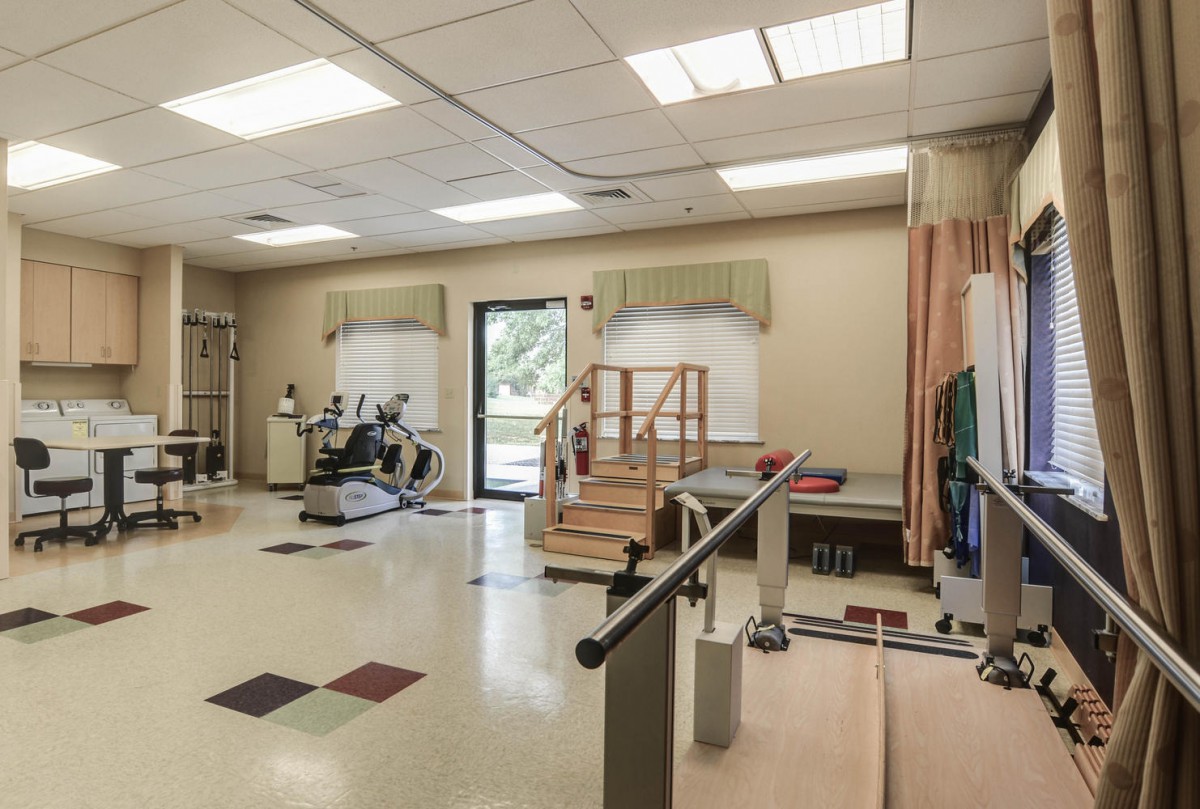 A rehabilitation room equipped with exercise apparatus and therapy tools.