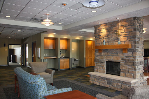 A welcoming lobby area featuring a stone fireplace and comfortable seating.