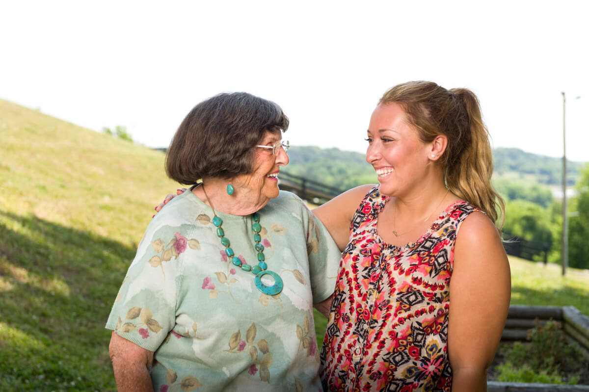 A joyful moment between two women sharing a connection outdoors.