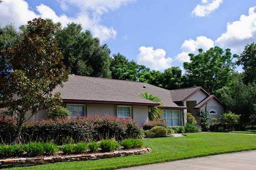 A charming suburban home with a well-maintained lawn and garden.