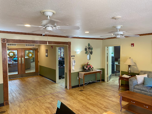A welcoming lobby featuring ceiling fans and a warm wooden floor, perfect for relaxation.