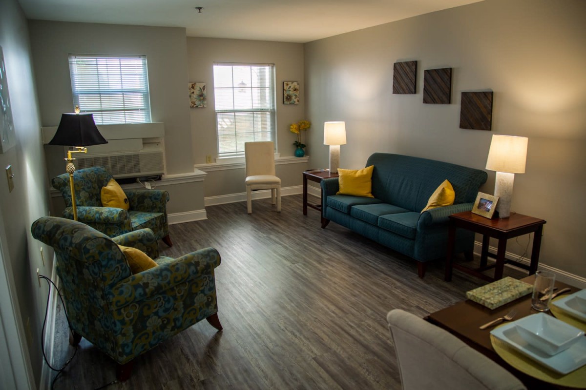 A cozy living room with modern furnishings and warm lighting.