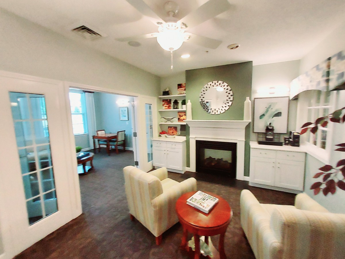 A cozy living room with a modern fireplace and comfortable seating.