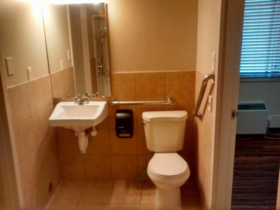 A small bathroom with a sink and toilet next to each other.