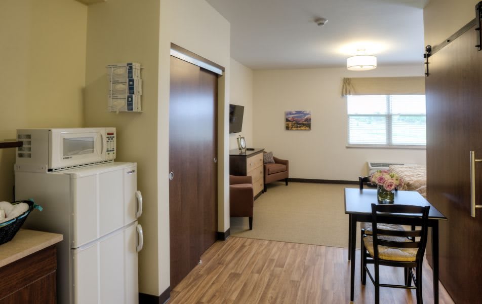 A well-organized living space with a kitchenette and dining area.