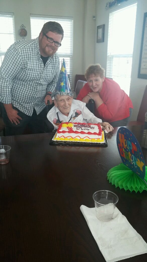 A joyful birthday celebration with a cake and party hat.