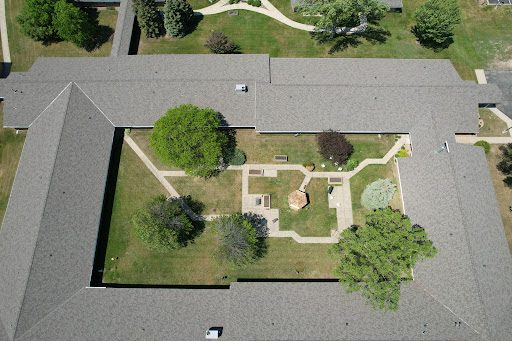 Aerial view of a beautifully landscaped garden with pathways and trees.