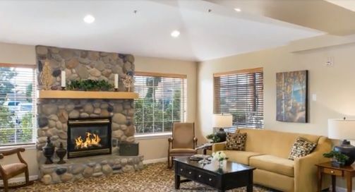 Cozy living room with a stone fireplace and comfortable seating.