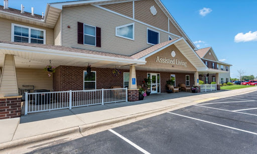 A welcoming entrance to a residential care facility, featuring a well-maintained exterior and accessible parking.