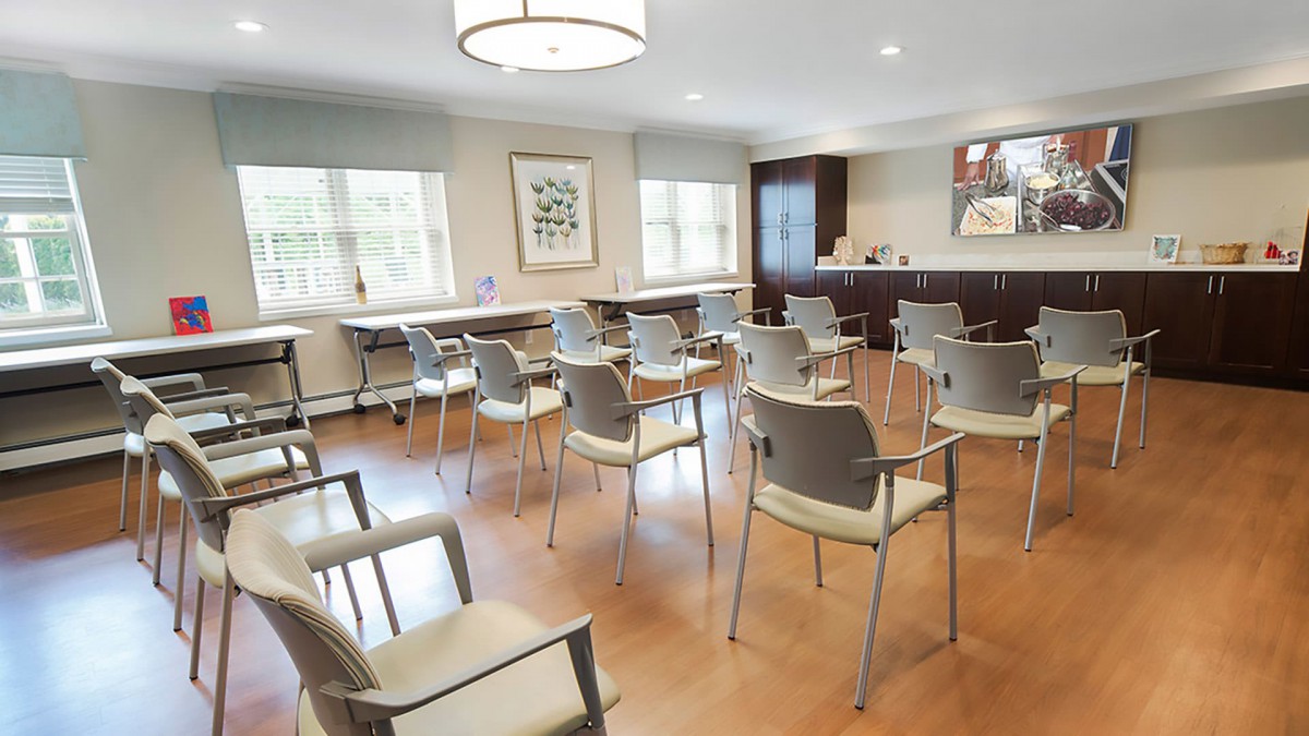 An empty waiting room with arranged chairs and a clean, modern interior.