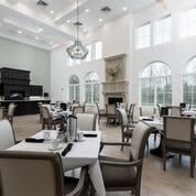 Elegant dining room with high ceilings and large windows.