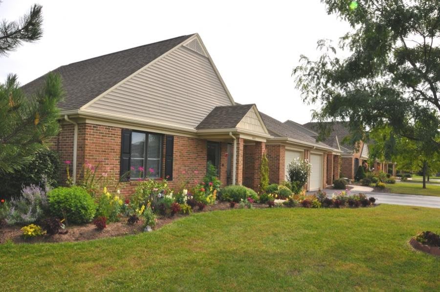 A suburban house with a well-maintained lawn and garden.
