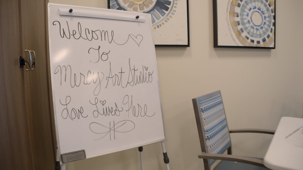 A welcoming message on a whiteboard in an office setting.