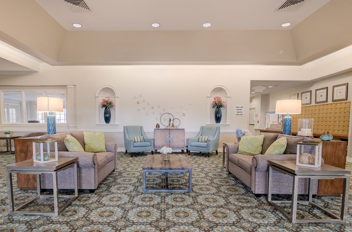 A spacious and elegantly designed living room with comfortable seating and decorative elements.