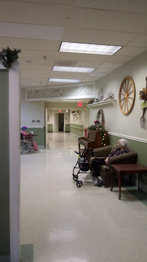 A serene hallway in a nursing home, showcasing residents engaging with their surroundings.