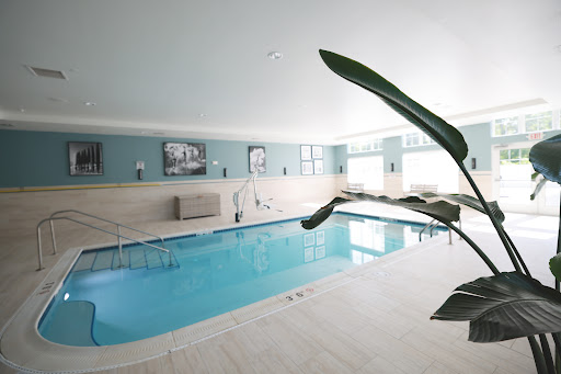 A serene indoor swimming pool with modern decor, perfect for relaxation and fitness.