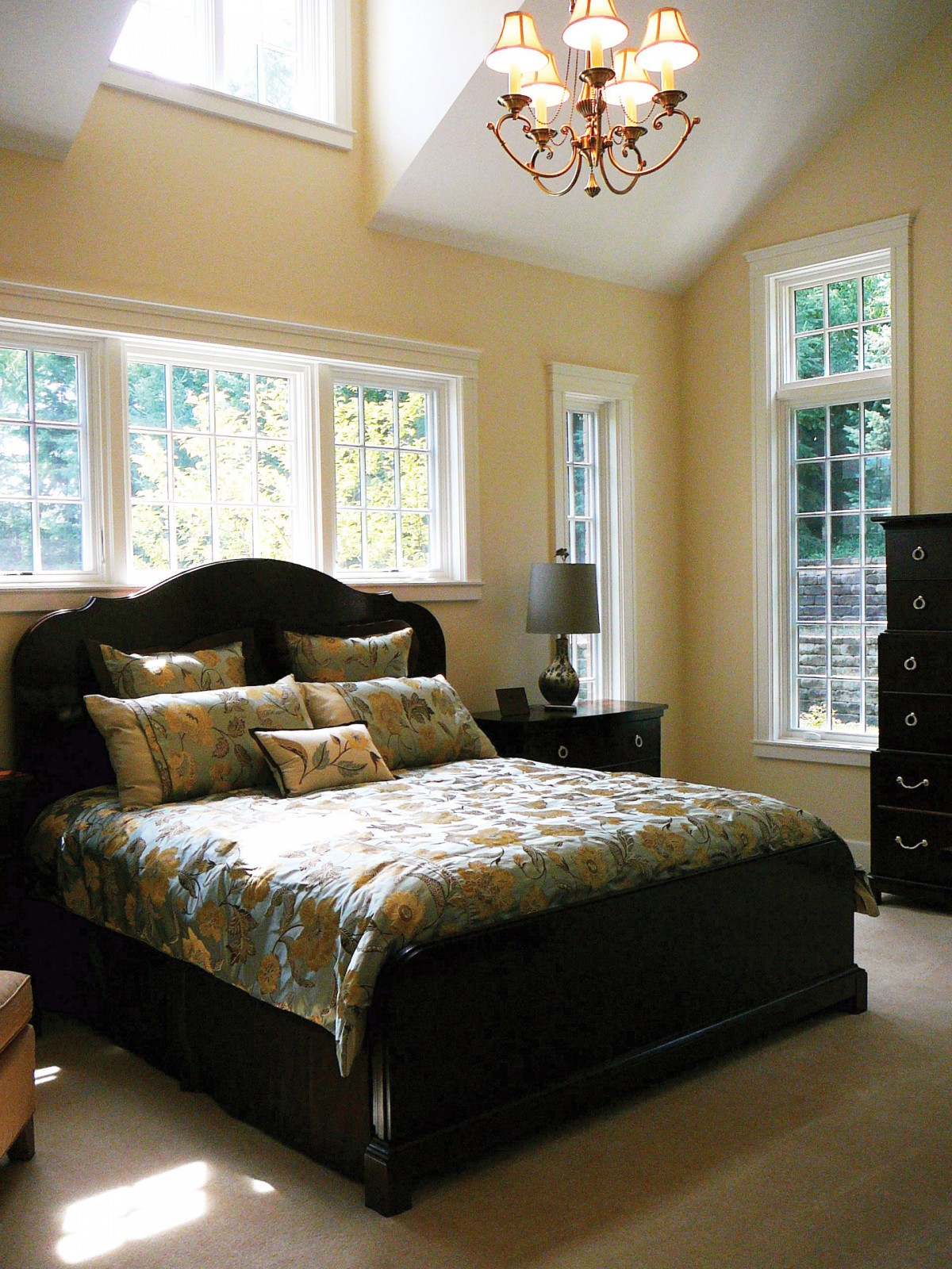 A cozy bedroom with elegant furniture and large windows.