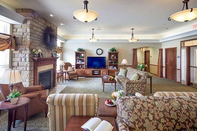 A cozy living room with a fireplace, TV, and comfortable seating.