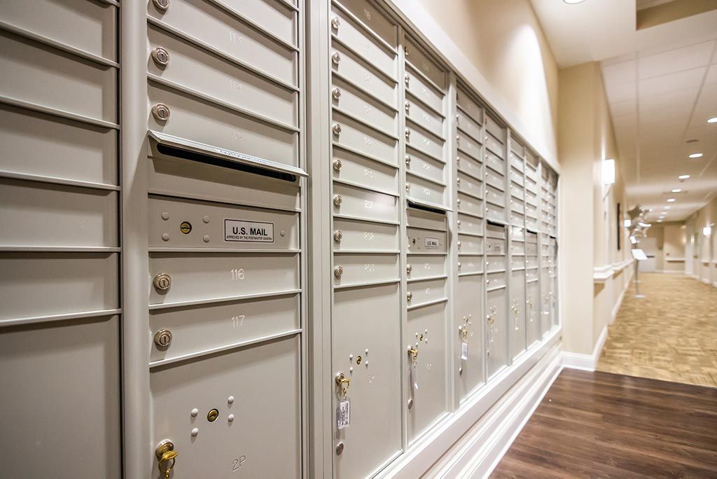 A row of indoor mailboxes in a hallway.