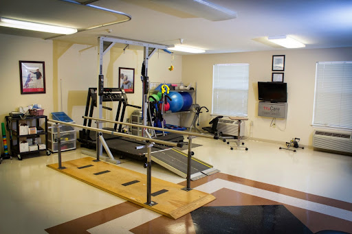 A rehabilitation gym equipped with various exercise machines and tools for physical therapy.