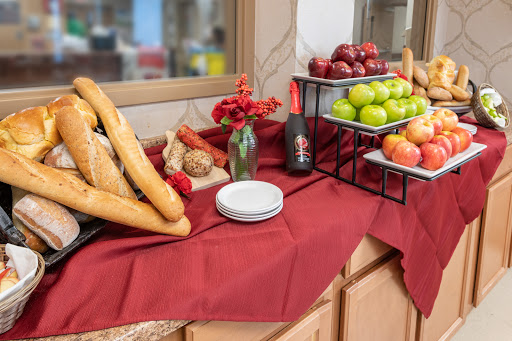 A beautifully arranged table featuring an assortment of bread and fresh fruits, perfect for a gathering.