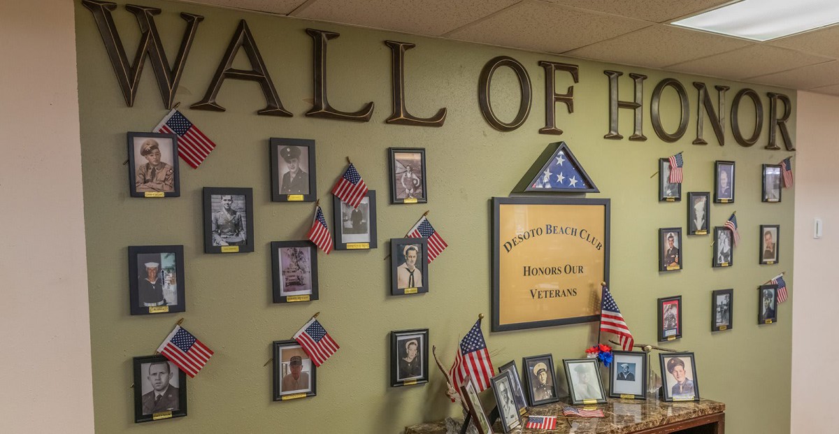 A Hall of Heroes display honoring veterans with photographs and American flags.
