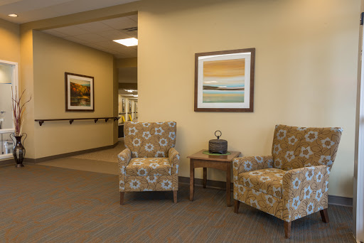 A cozy waiting area featuring patterned chairs and contemporary artwork.