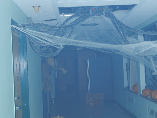 An interior space undergoing renovation, covered with blue plastic sheeting.