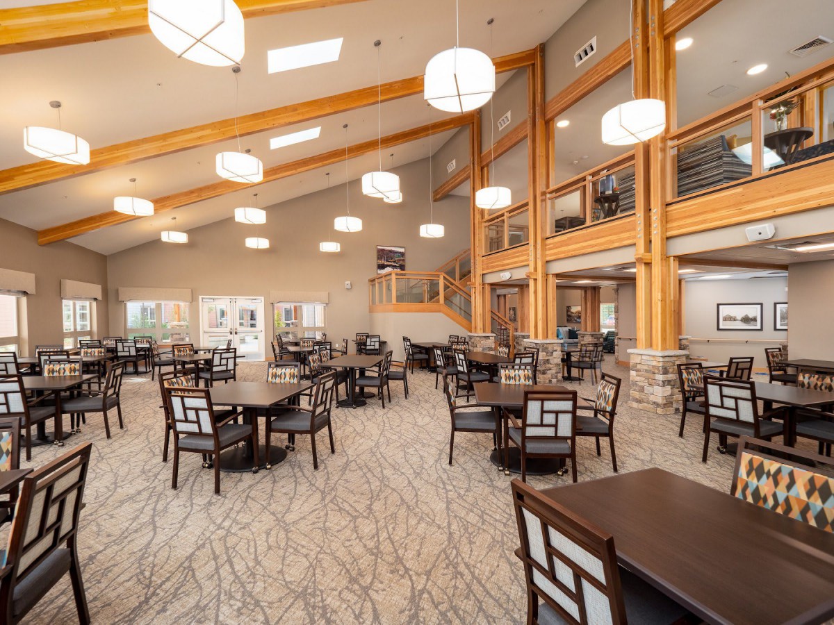 A spacious and modern dining area with elegant furniture and ambient lighting.