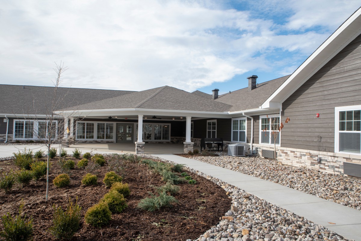 A modern residential house with landscaped yard and pathway.