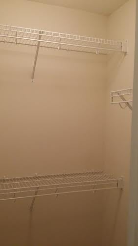 An empty closet with shelves ready for organizing.