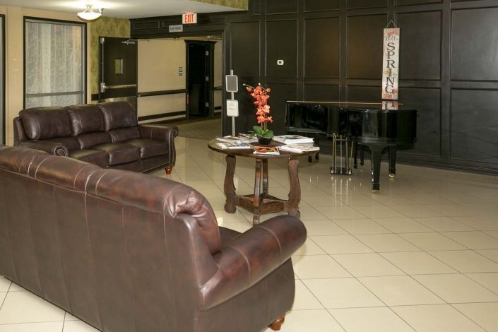 A cozy lobby with leather sofas and a central table.