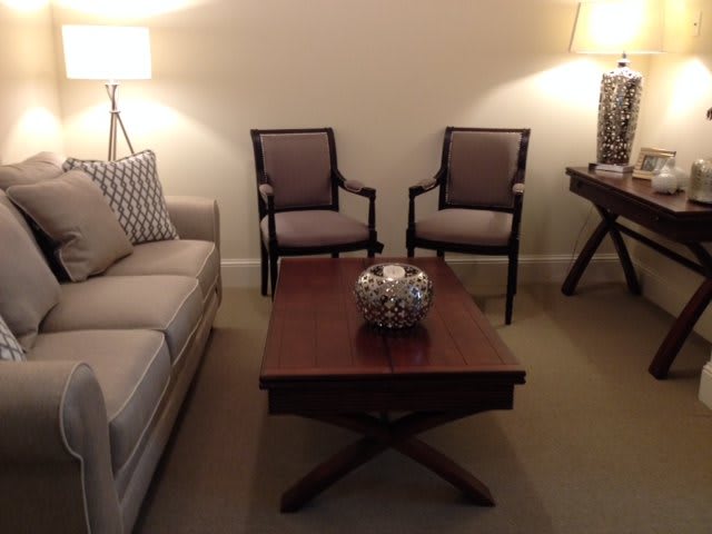 A cozy living room with elegant seating and subtle lighting.