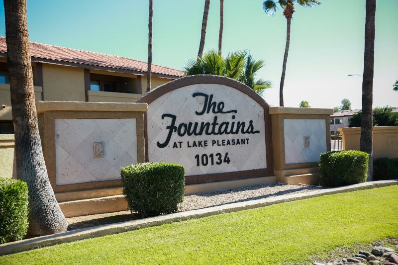 Entrance sign for The Fountains at Lake Pleasant apartment complex.
