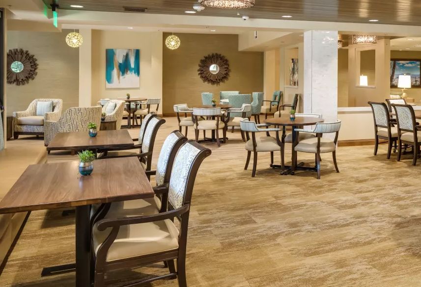 A modern dining area with neatly arranged tables and chairs, featuring stylish interior decor.