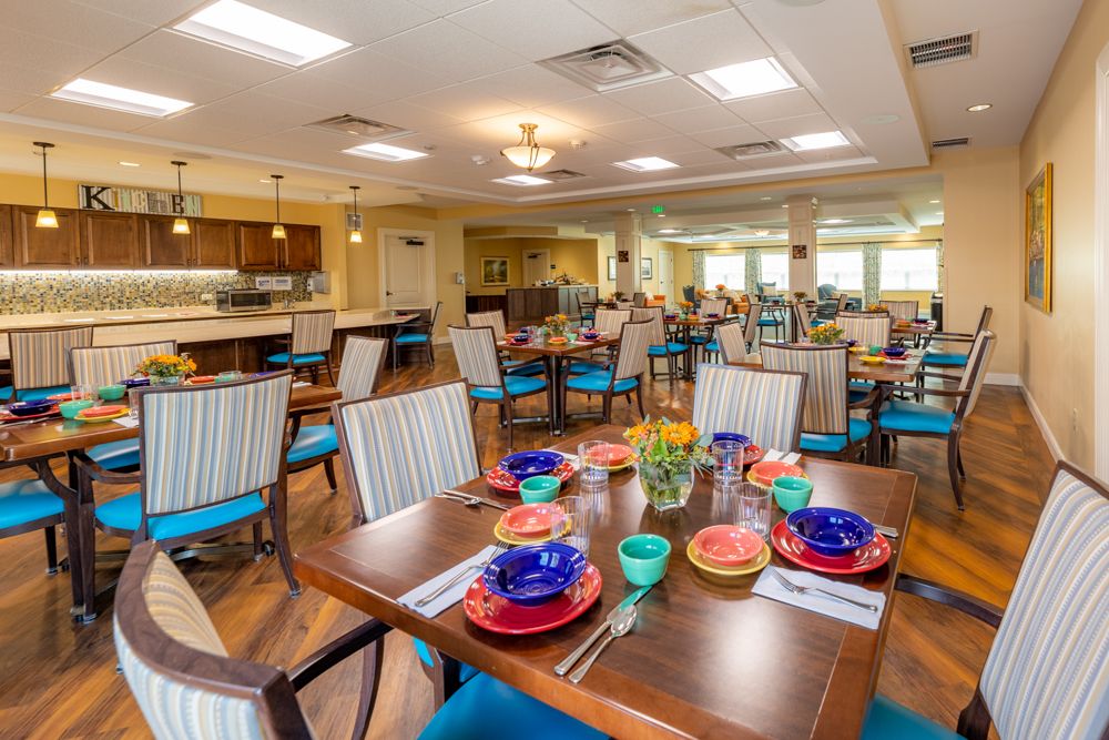 A brightly decorated dining area with colorful plates and neatly arranged tables and chairs.