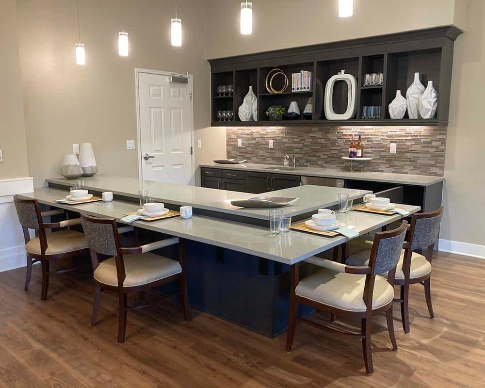 A modern kitchen and dining area with stylish decor and seating.