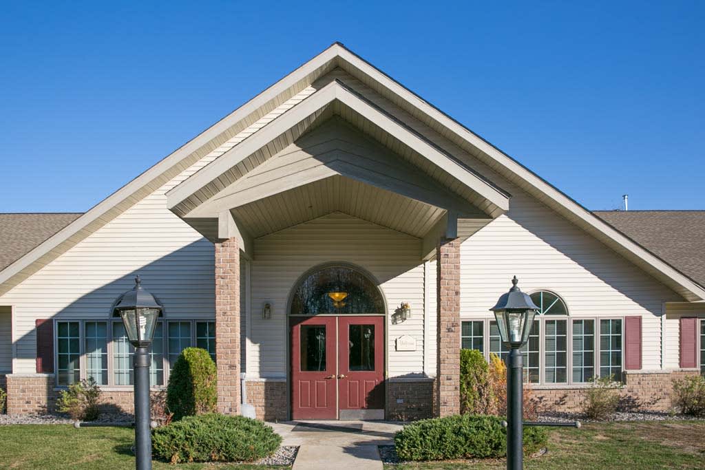 A front view of a house with a prominent entrance and well-maintained landscaping.