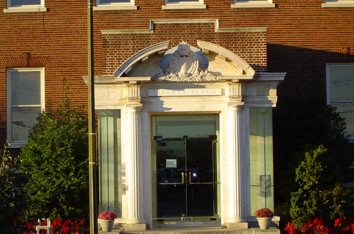 An ornate building entrance with columns and decorative elements.