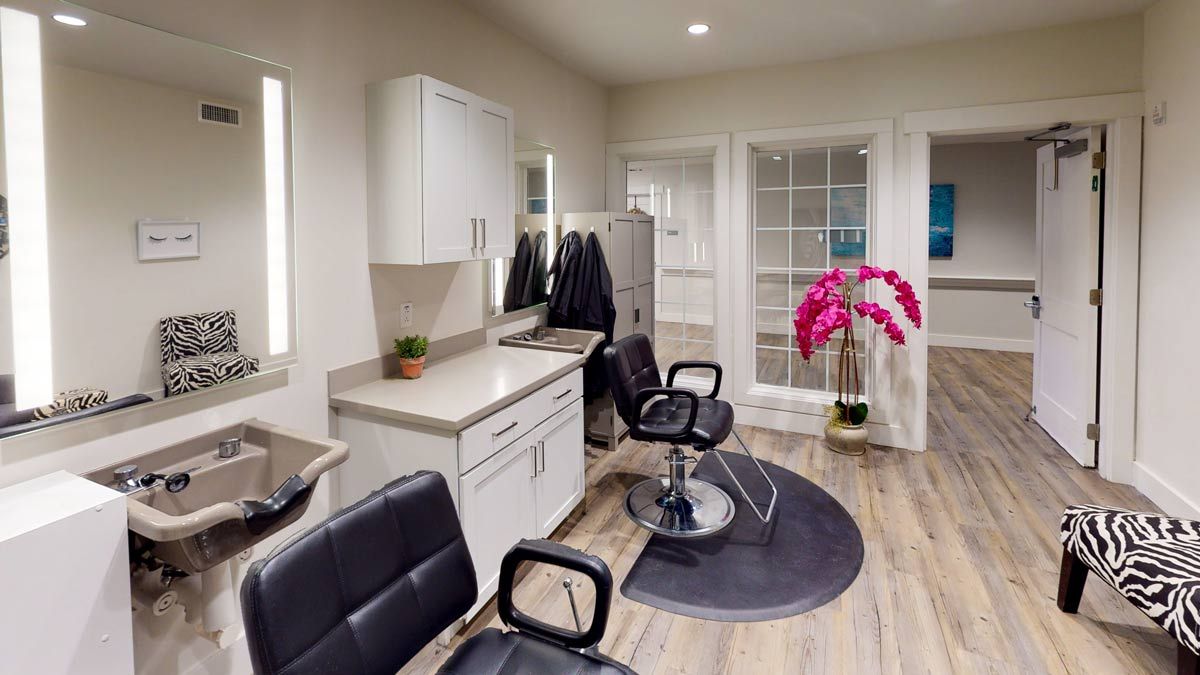 Modern salon interior with styling chairs and bright lighting.