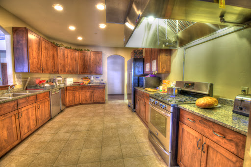 A spacious and modern kitchen featuring wooden cabinets and stainless steel appliances.